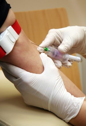Trussville Alabama licensed practical nurse drawing blood sample from arm of patient